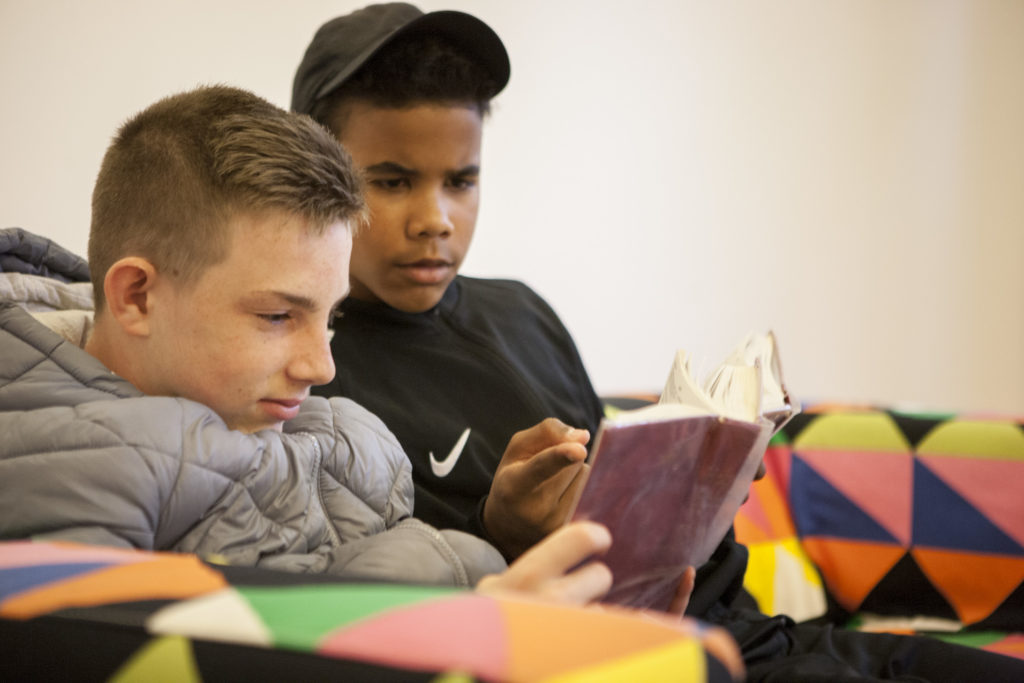 Two teenage boys looking at the bible